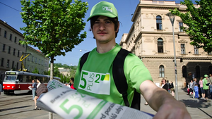 Street vendor offers copy of 5plus2 weekly.